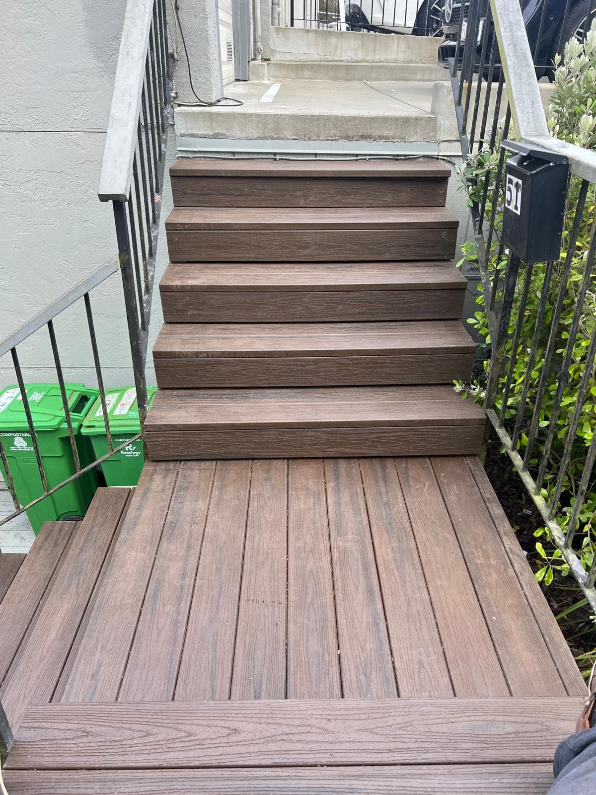 picture of a new small stair deck recently installed in the front of a home 